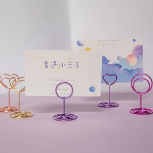 Colorful heart and round metal card holders with spiral bases for table desktop display