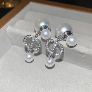 Elegant silver-tone double pearl earrings with crystal-encrusted CD charms and studs