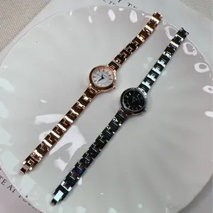Close-up of stylish ladies quartz watches with metallic mesh bands and rhinestone markers