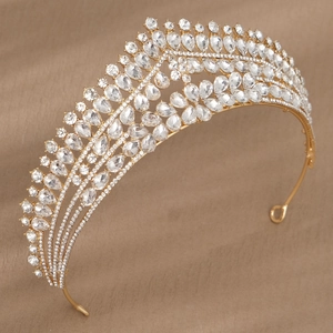 Detail of luxury gold bridal crown with shimmering pear-cut rhinestones on velvet