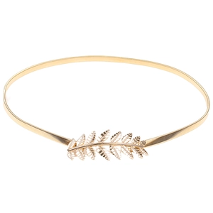 Detailed view of golden leaf decorative buckle on elastic metal spring waist belt