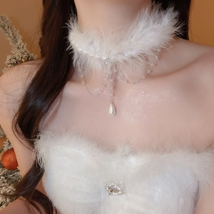 Detail of elegant white feather and pearl choker with water drop pendant on neck