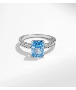 Close-up of s925 silver ring with rectangular ice-cut light blue zircon and side stones