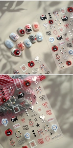 Detail view of M-1231 embossed Christmas nail stickers with black cat and snowman patterns