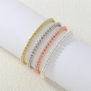 Detailed close-up of 18K gold plated beaded stretch bracelets in four metallic tones