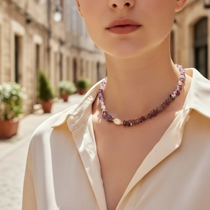Bohemian purple stone necklace with a baroque pearl and gold accents on a model