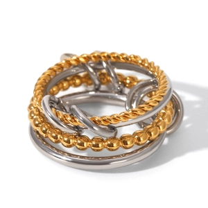 Detail view of multi-layer mixed metal rings with twisted rope and bead chain textures