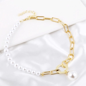 Detailed close-up of Baroque pearl necklace with gold paperclip chain and large pearl pendant