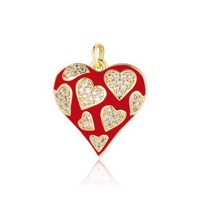 Detail of a red enamel heart pendant with inlaid crystals and a gold-plated border