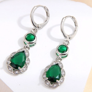 Macro detail of teardrop green zircon earrings with silver pavé cubic zirconia setting