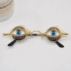 Creative gold metallic sunglasses with 3D eye shape and blue eyeball decor for women