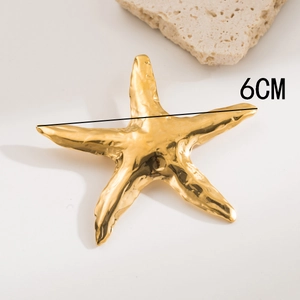 Close-up of golden starfish brooch with textured surface and 6cm diameter measurement