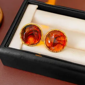 Vintage round resin stud earrings with amber texture and gold beaded metal trim