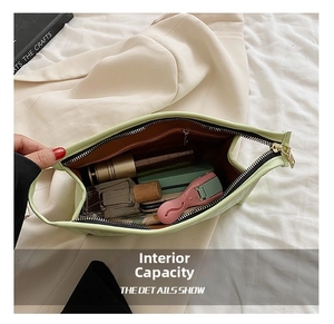 Detail showing high-capacity interior of light green quilted cosmetic bag with brown lining