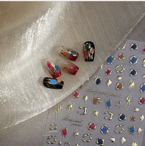 Macro shot of French leopard print nail art stickers with gold foil geometric lines
