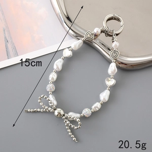 Detail view of 15cm pearl bead wrist strap with silver heart and rhinestone ball