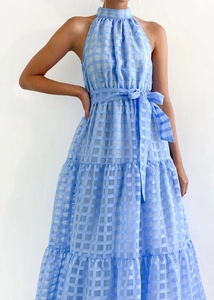 Detail of light blue plaid halter dress featuring tiered skirt and waist tie design