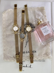 Three elegant gold BARSH quartz watches on lace cloth with milanese mesh bands