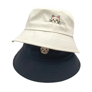 Black and beige cotton bucket hats featuring cute cat embroidery in a vertical stack