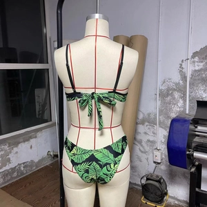 Close-up of tropical palm leaf print bikini set with spaghetti straps on mannequin