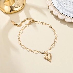 Detailed macro of 18K gold plated heart pendant on a stainless steel paperclip chain