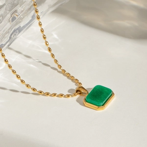 Detail of 18k gold stainless steel necklace featuring a green tiger eye stone pendant
