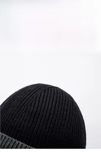 Close-up of black ribbed knit beanie showing thick texture and warm fleece material