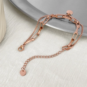 Detail of rose gold double-layer chain bracelet featuring rectangular links and lobster clasp