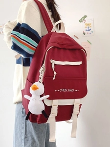 Cute red high-capacity student backpack with multi-pocket design and small duck pendant