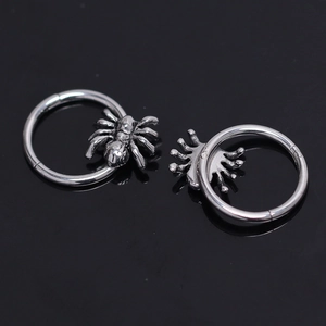 Gothic style stainless steel spider hoop earrings with a polished silver metallic finish