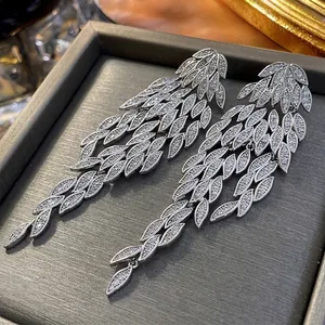 Luxury silver leaf tassel earrings with sparkling cubic zirconia on a jewelry display box