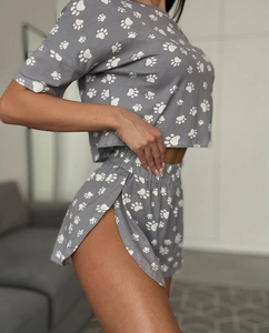 Detail of soft dark grey pajamas with white paw print and elastic side-slit shorts