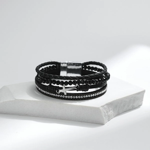 Detail of multilayer PU leather bracelet with silver cross pendant and crystal chain