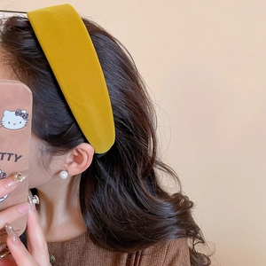 Detail of yellow velvet wide headband worn by model with elegant pearl earring