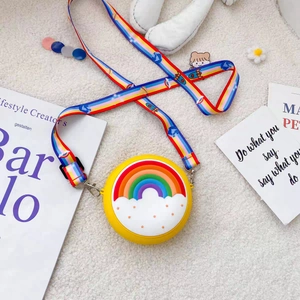Detail of yellow donut silicone kids purse with rainbow relief and cartoon strap