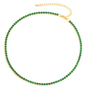 Flat lay of gold tennis necklace with green zircon stones and lobster clasp closure