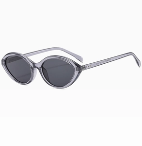 Detail view of cat eye sunglasses with grey translucent frame and dark lenses