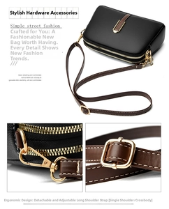 Detail view of black lychee grain leather crossbody bag with dual zippers and gold hardware