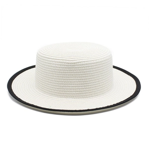 Detailed top view of white boater straw hat with black piping and woven texture