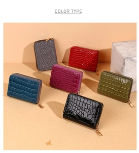 Close-up of crocodile pattern leather card holders in six vibrant colors with metal zippers