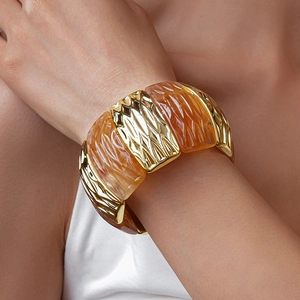 Detail of stretch bracelet with gold geometric metal and amber resin textured segments