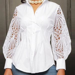 Detail of white long-sleeve blouse featuring intricate lace cutout sleeves and slim fit design
