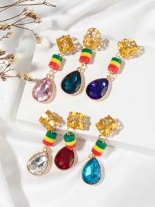 Detail of bohemian gold dreadlock pendants with colorful beads and crystal water drops