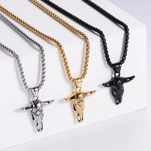 Detailed close-up of hollow bull skull pendants in silver, gold, and black steel finishes
