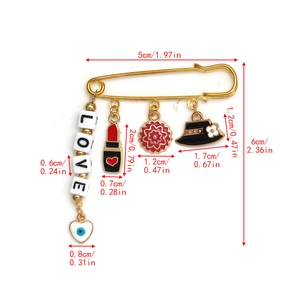Detailed view of evil eye gold safety pin brooch with charms and precise dimensions