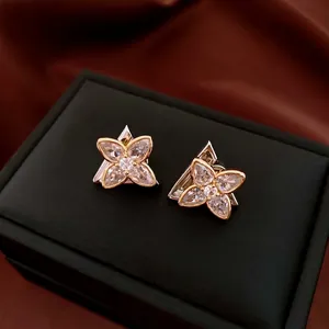 Exquisite flower stud earrings with marquise-cut crystals in a gold and silver setting