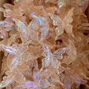 Macro shot of iridescent butterfly acrylic charms with a pearlescent finish for DIY crafts