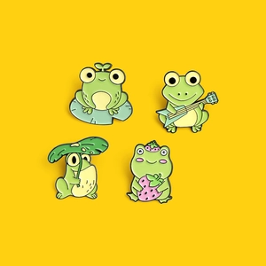 Set of four cute green frog enamel pins with strawberry and guitar on bright yellow background