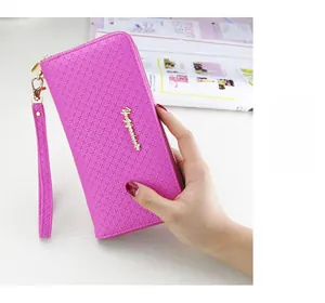 Detail of magenta long wallet featuring cross-grain texture and secure zipper wristlet