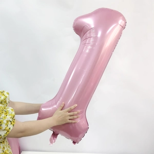 Detail of a large 40-inch pearlescent pink number 1 foil balloon for birthday party decor